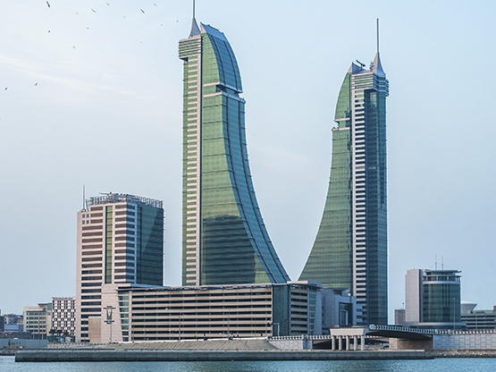 A stunning waterfront view of Bahrain Financial Harbour, with its distinctive twin towers rising gracefully against the skyline—home to Servcorp serviced offices,