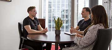 Clients holding a productive meeting in a Servcorp private office.