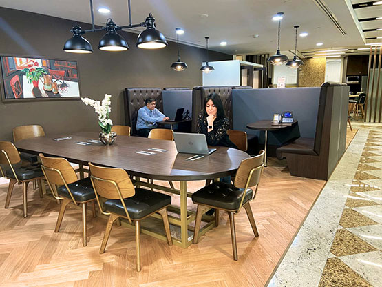Professionals working within Servcorp’s stylish coworking space, at Boulevard Plaza, Dubai